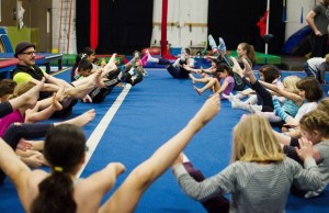 Nick Harden (far left) leads students through a warm up to get their muscles ready before splitting off into the different age grouped classes.  Photo by Seth Halleran